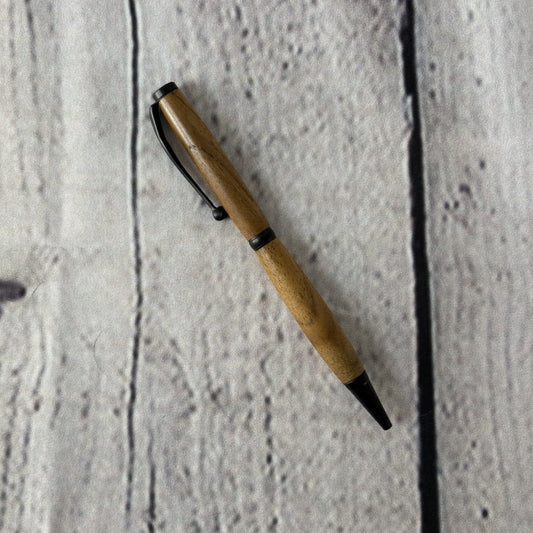 Slimline ballpoint pen with teakwood and black fittings